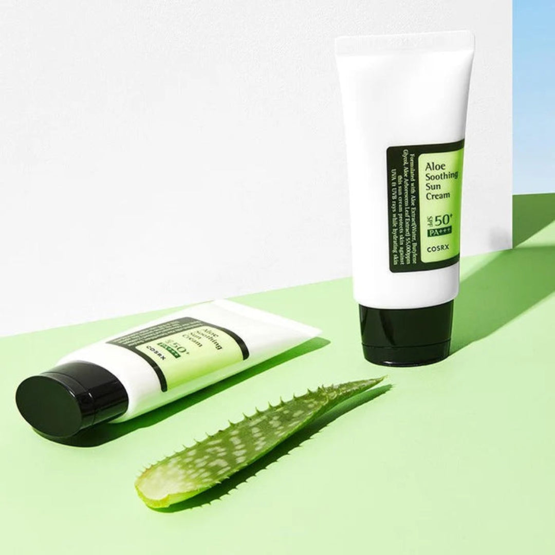 Two tubes of aloe vera sunscreen with aloe vera leaves on a green background