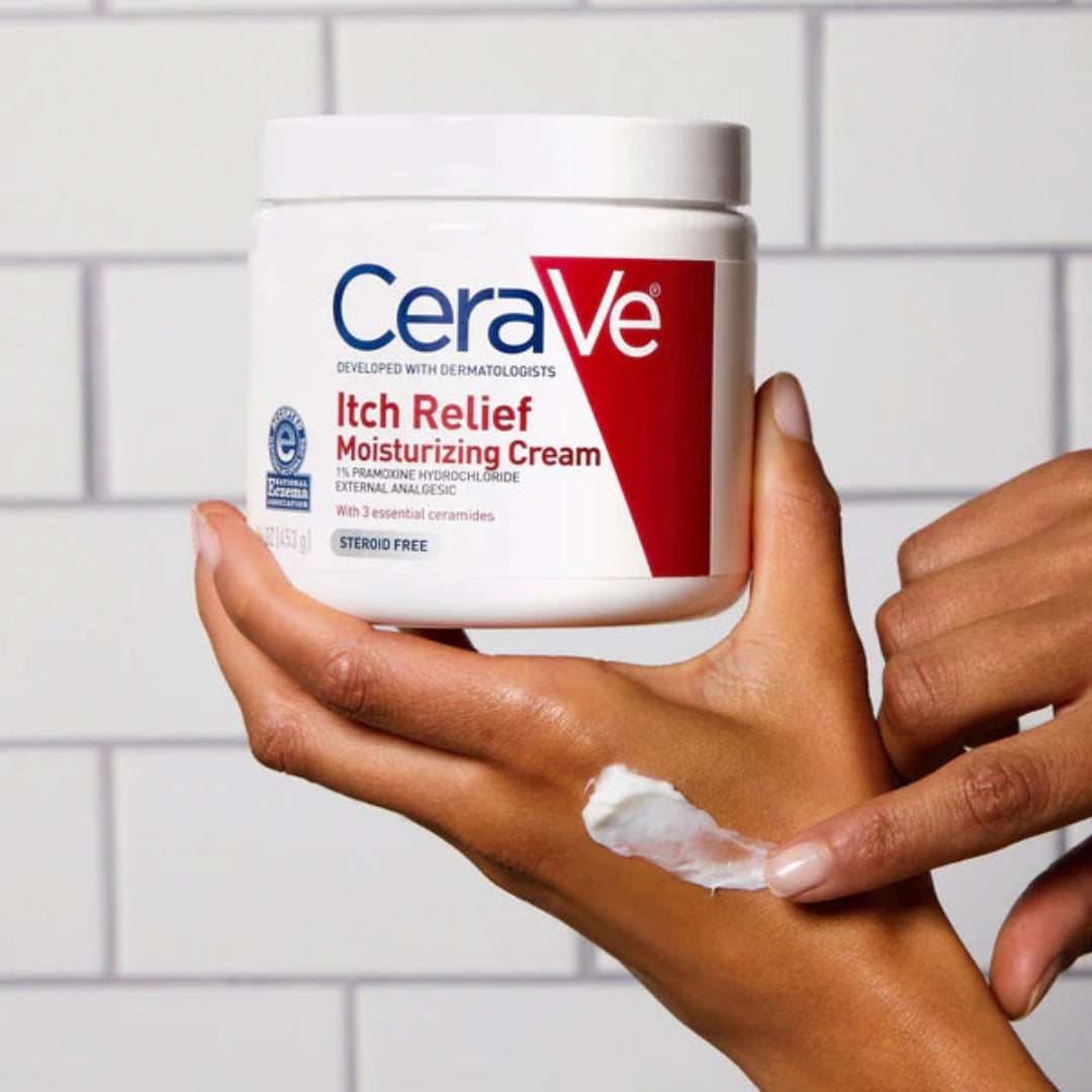 CeraVe Itch Relief Moisturizing Cream being applied to a hand against a tiled wall background