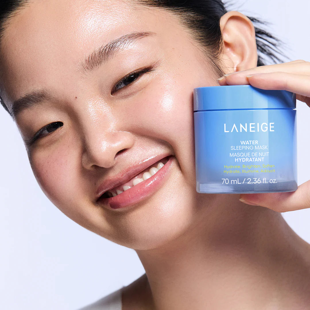 Woman holding a Laneige product with a plain background