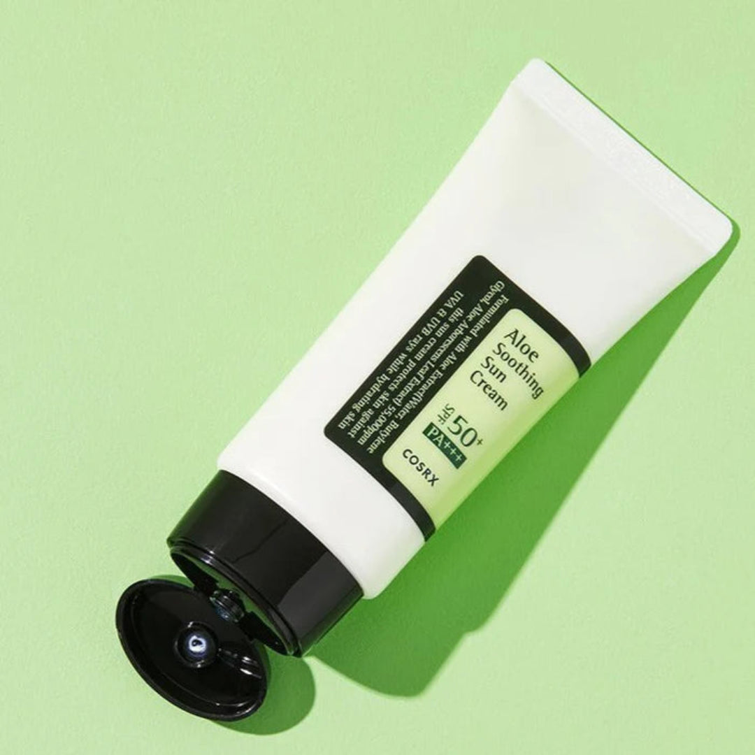 Cosrx Aloe Soothing Sun Cream tube on a green background