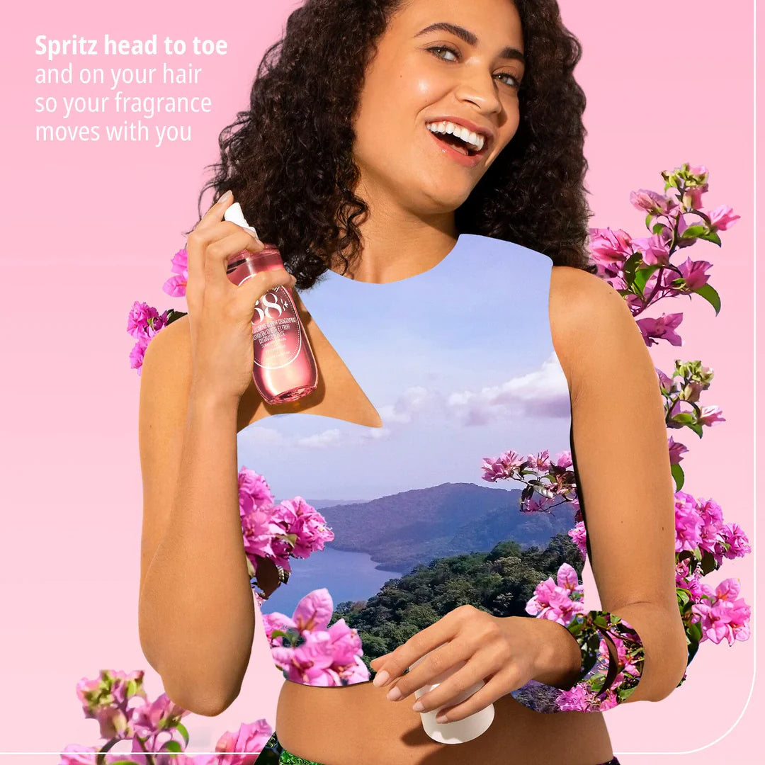 Woman holding a spray bottle with pink flowers and scenic background