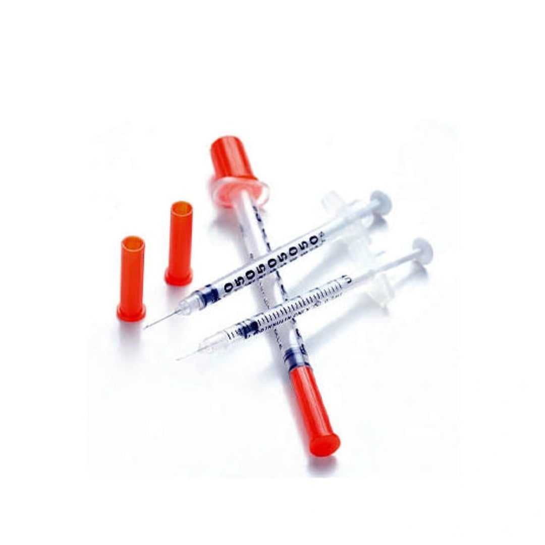 Four medical syringes with red plungers and orange caps, arranged on a plain white background.