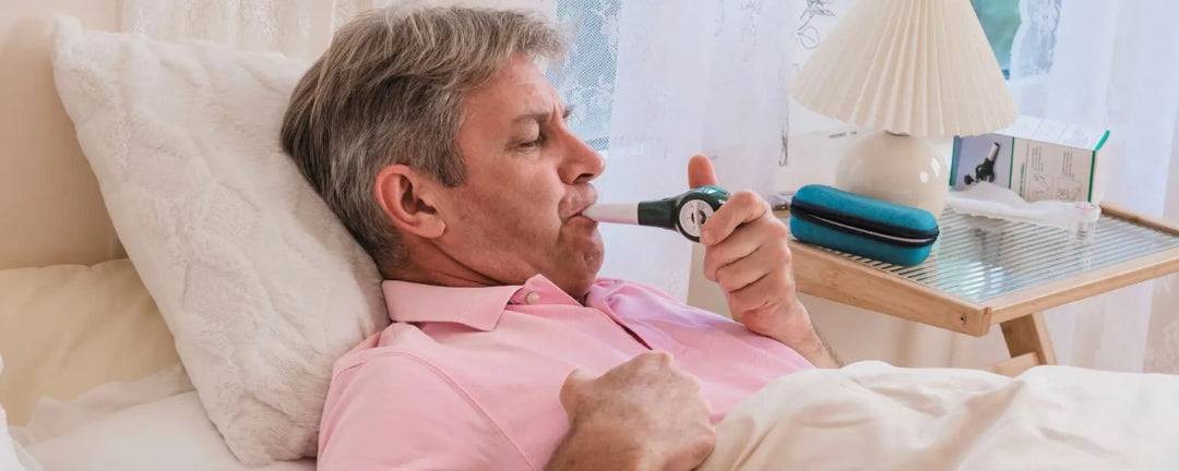 Man using respiratory muscle trainer  in a living room.